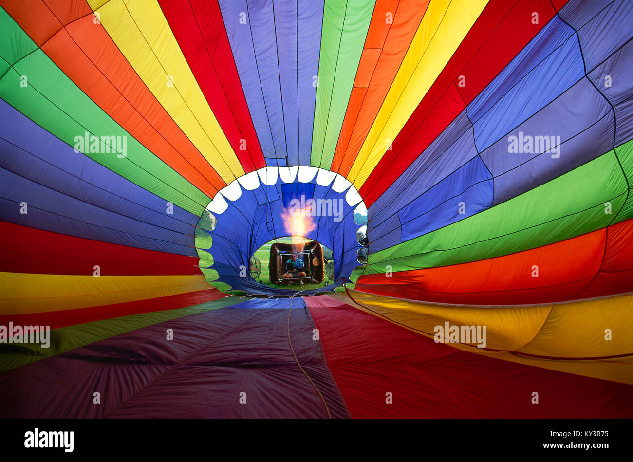 View from the inside of hot air balloon as fire heats the air the balloon rises off the ground. Stock Photo