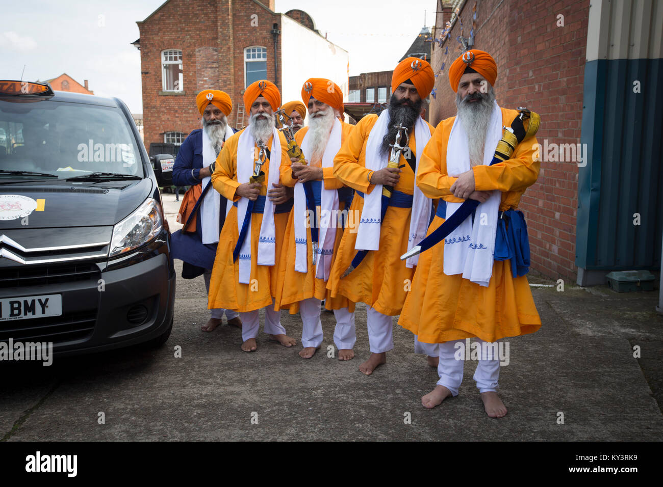 Sikhs arriving at their temple in Leicester, England before a bi-annual procession through the city's streets. According to the 2011 census, there were 14,500 people of the Sikh faith living in Leicester,  around five per cent of the local population. The local football club, Leicester City, were on the brink of being surprise winners of the English Premier League in the 2015-16 season. Stock Photo