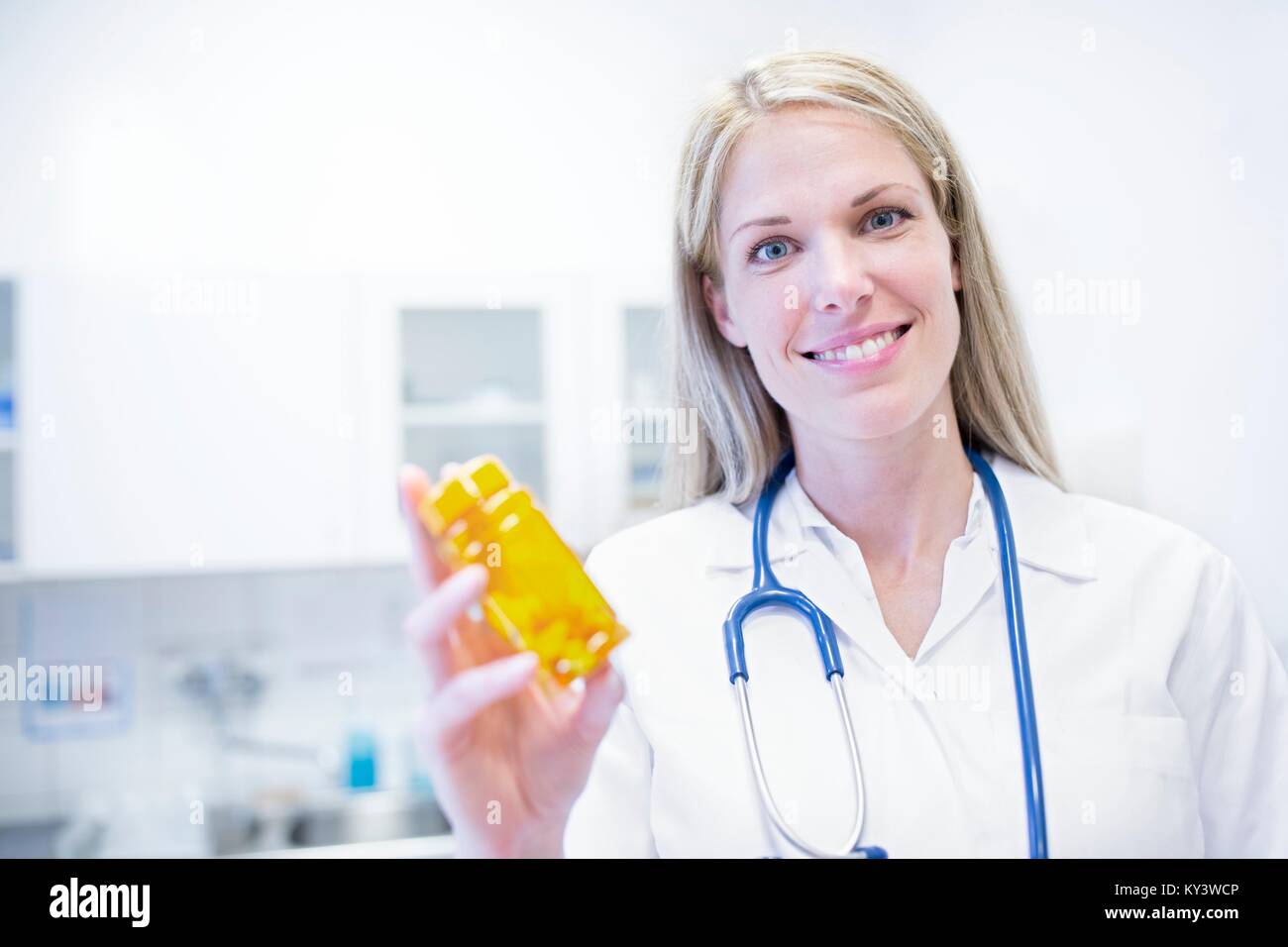 Female doctor holding pills. Stock Photo