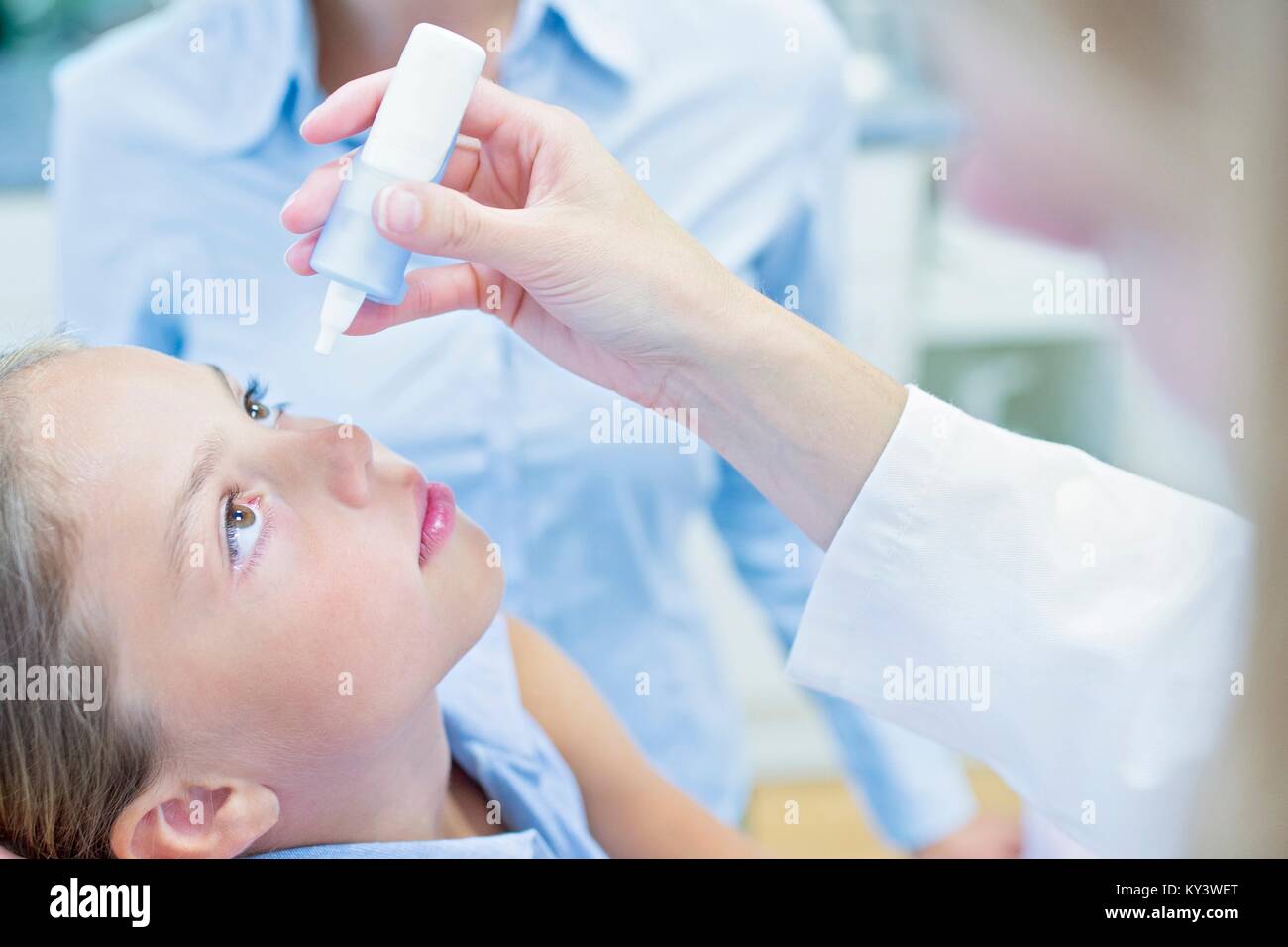Doctor putting eye drops into young girl's eye Stock Photo Alamy