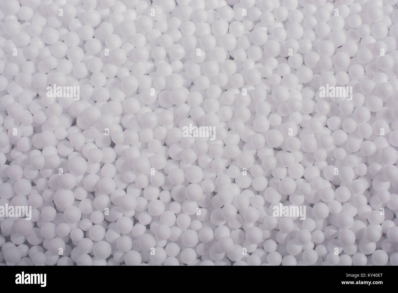 White little polystyrene foam balls as background Stock Photo - Alamy