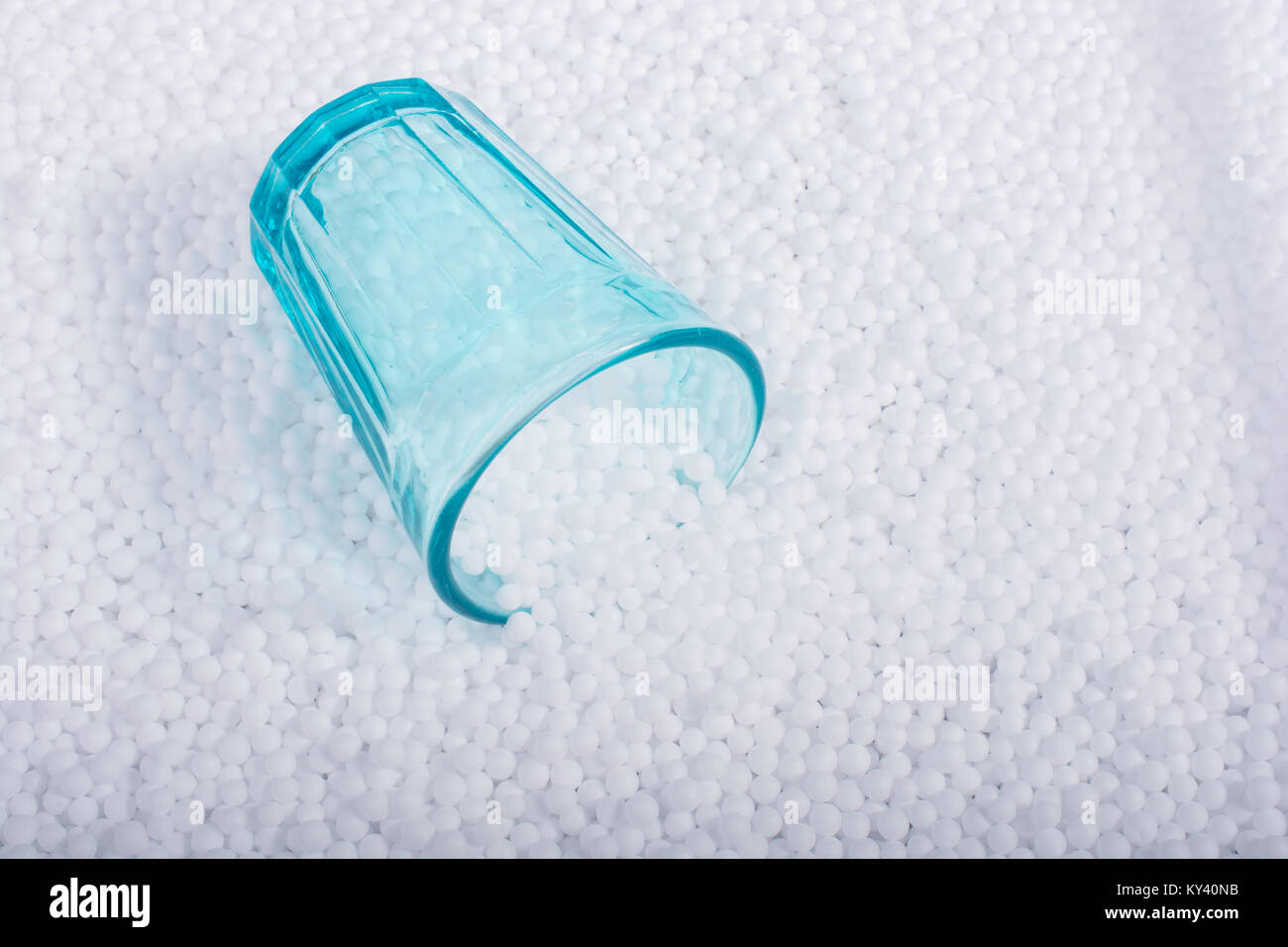 Empty glass on little white polystyrene foam balls Stock Photo - Alamy