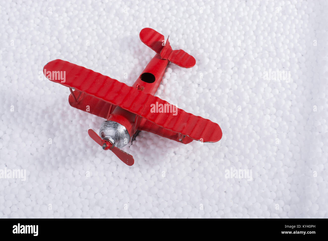 Toy airplane on little white polystyrene foam balls Stock Photo - Alamy