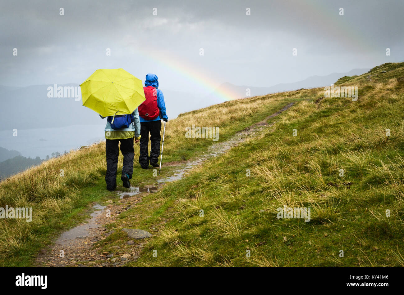 Rainbow, hikers in rain, descending to Patterdale, England, England's Coast to Coast Path, Stock Photo