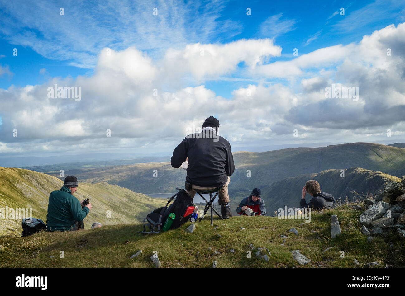 Hikers resting,  near Patterdale, Cumbria, England; England's Coast to Coast Path Stock Photo