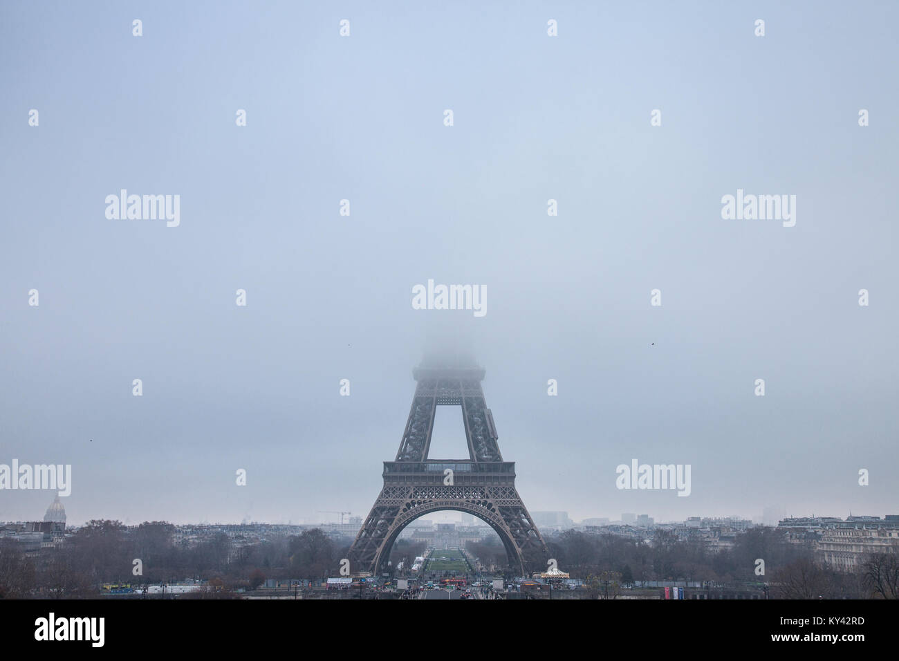 PARIS, FRANCE - DECEMBER 19, 2017: Panoramic view of the Eiffel Tower seen from Trocadero terraces, the top of the tower hidden by clouds and fog due  Stock Photo