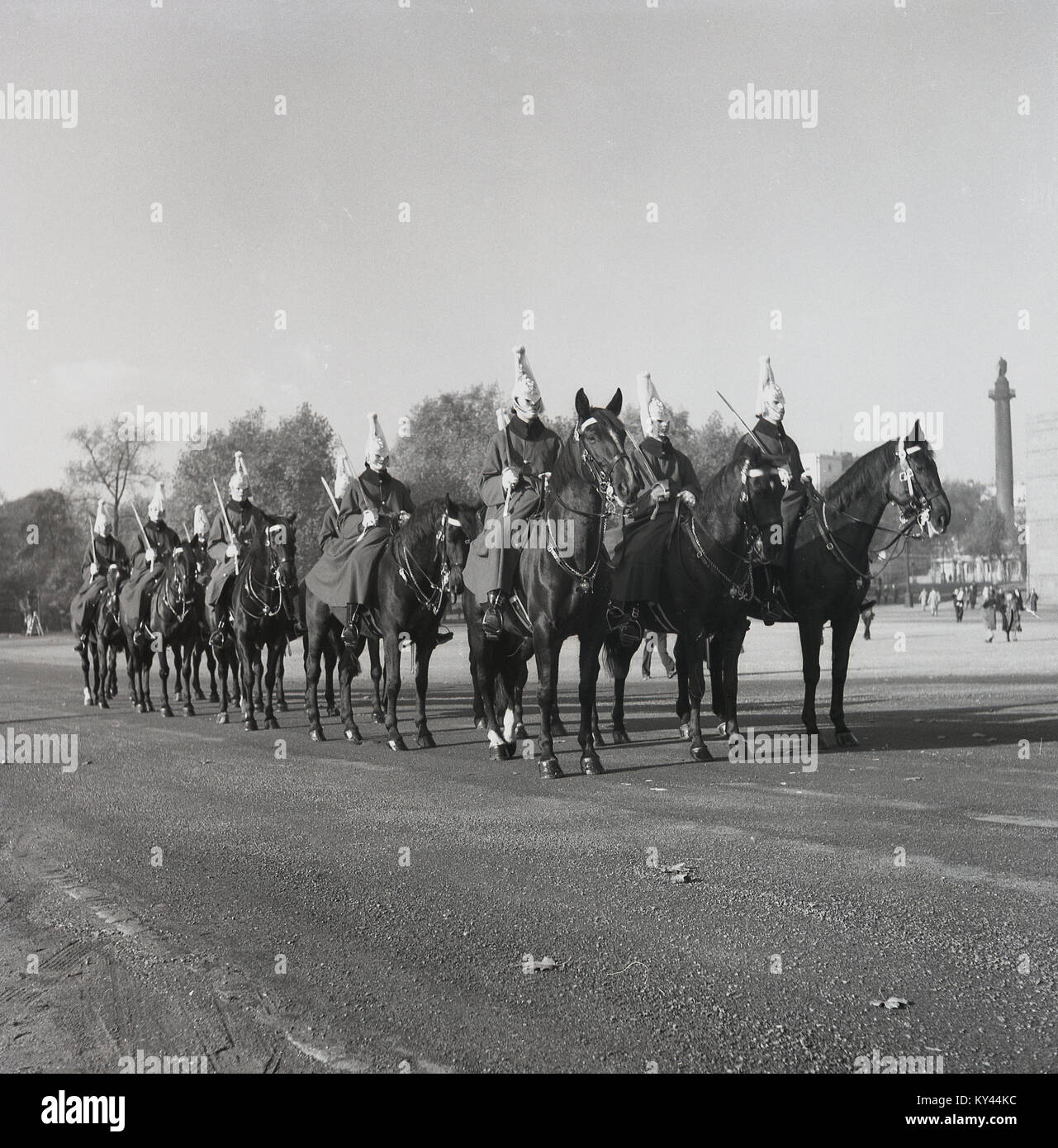 1950s, historical, mounted guards of the Queen's Household Cavalry  in training on the parade ground at Whitehall, London, England. Nelson's Column at traflagar square can be seen in the background. Stock Photo