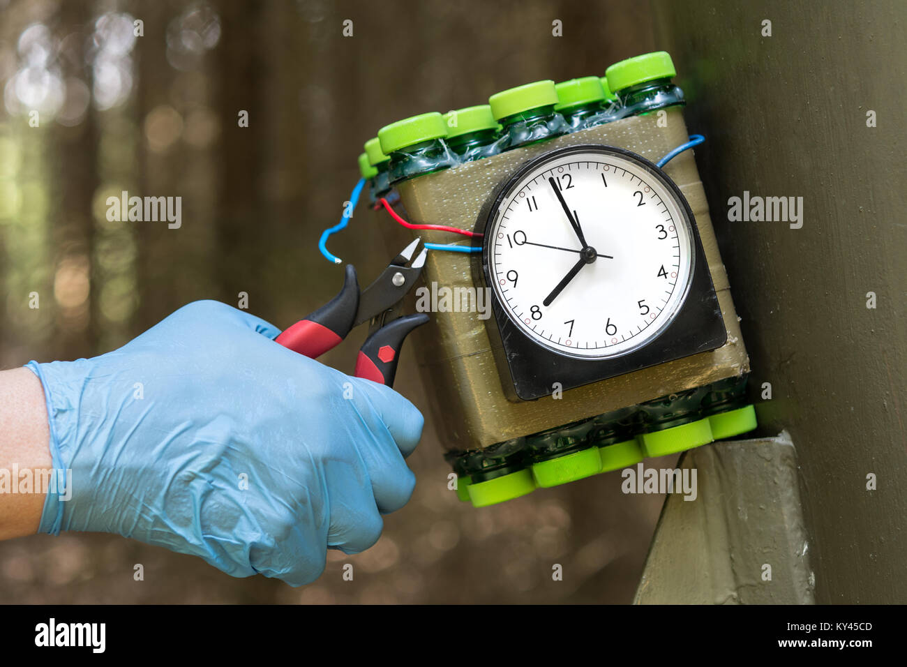 Deactivation of time bomb. Disposal of dangerous timebomb placed at a metal construction. Stock Photo