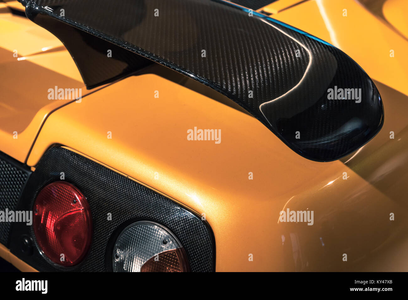 Luxury yellow sports car fragment, rear aerodynamics carbon spoiler and rear lights Stock Photo