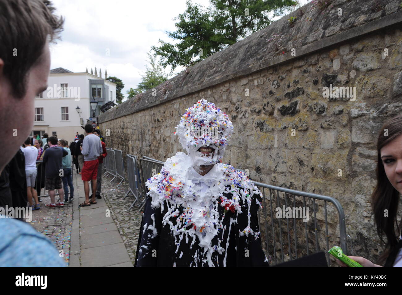 Students leaving their last exam meet friends for a traditional 'trashing' at the back of Oxford University Examination School, Oxford, England, UK. Stock Photo