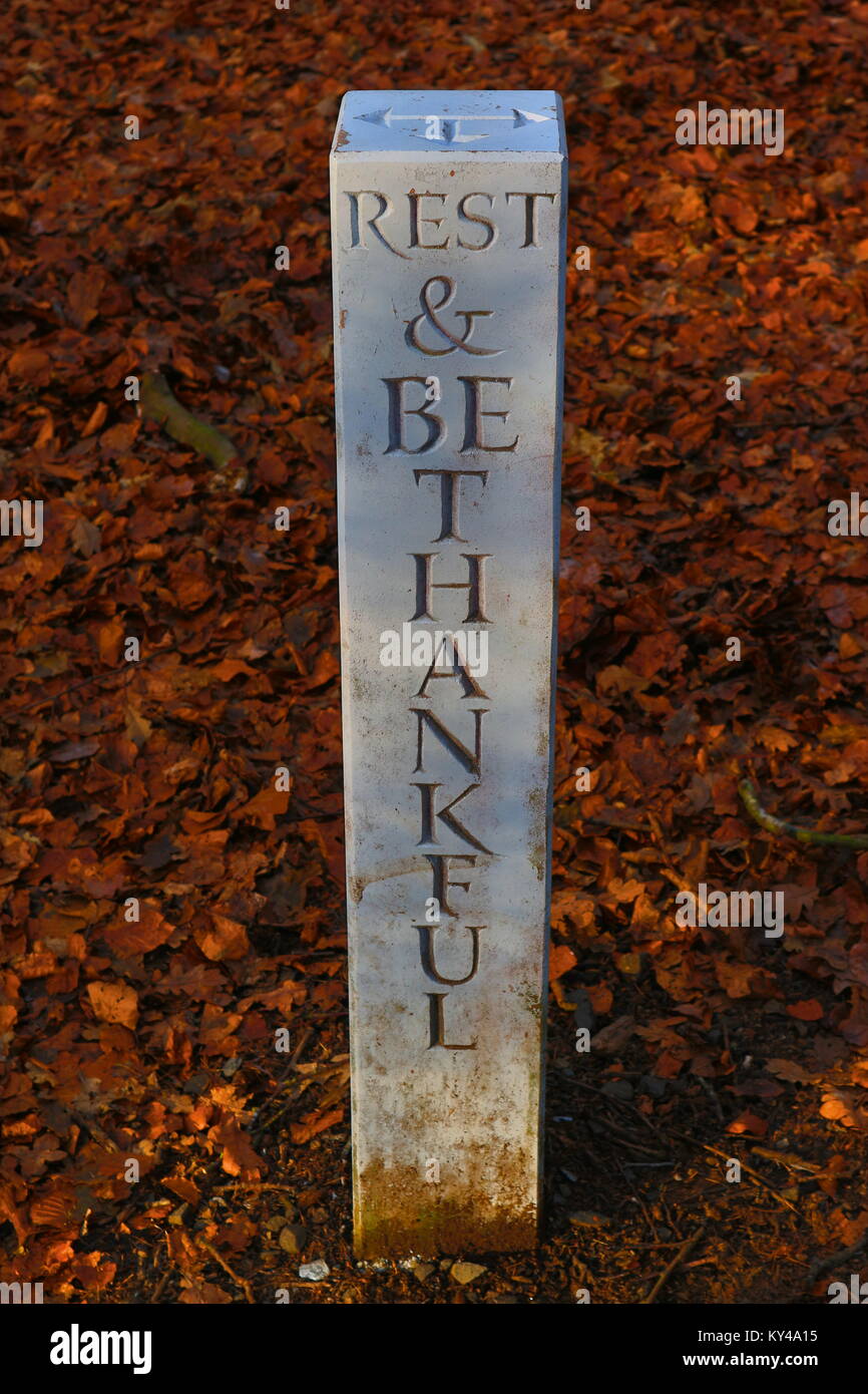 One of the many posts in the Corstorphine Hill Public Park in Edinburgh featuring the motto: 'rest and be thankful'. Stock Photo