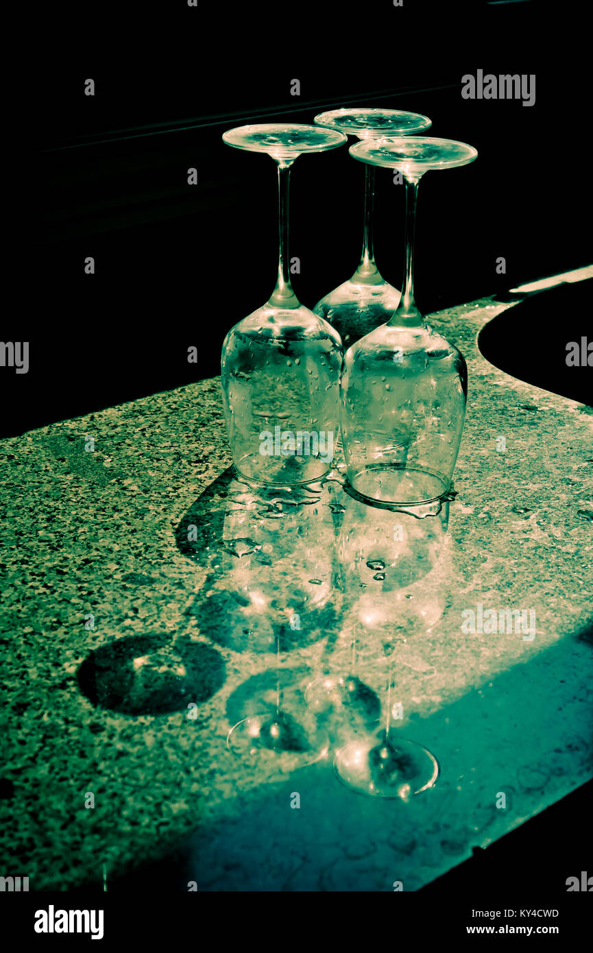 three glasses upside down on a counter top Stock Photo Alamy