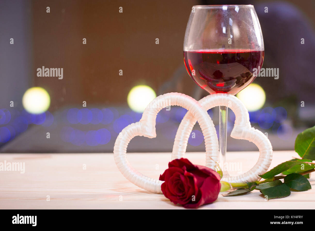 Two glasses of red wine with a red rose Stock Photo - Alamy