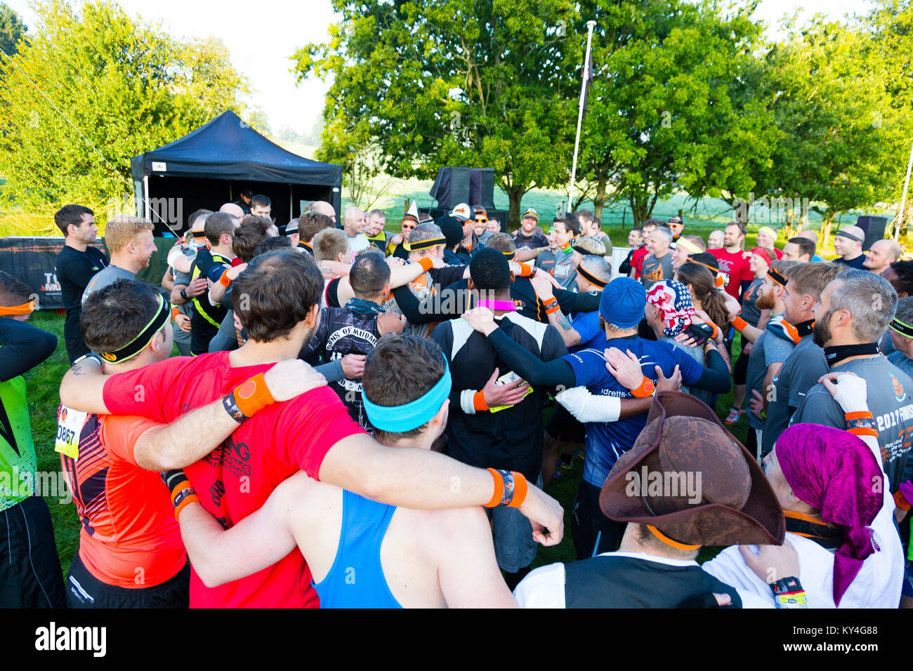 Sussex, UK. A large group of people embrace before they begin a Tough Mudder event. Stock Photo