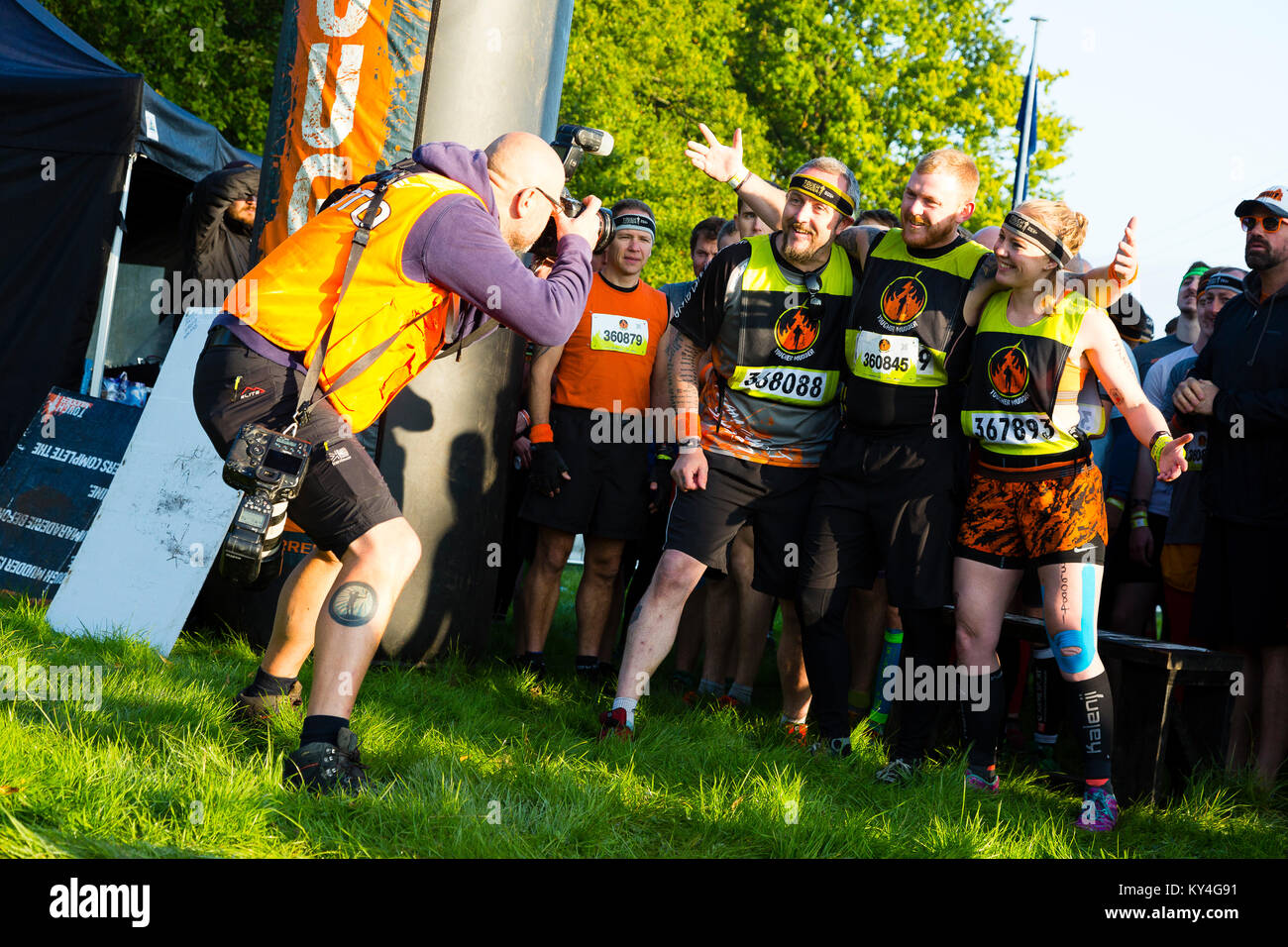 Sussex, UK. An event photographer takes a picture of competitors before they begin a Tough Mudder event. Stock Photo