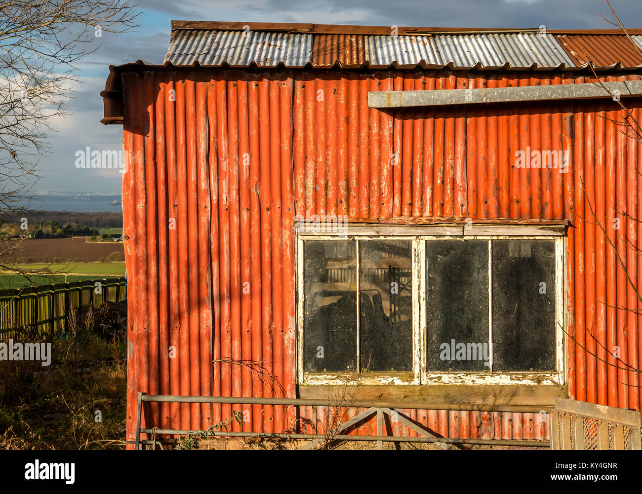 Dilapidated old tin shed with window, with rural background, East Lothian, Scotland, UK Stock Photo
