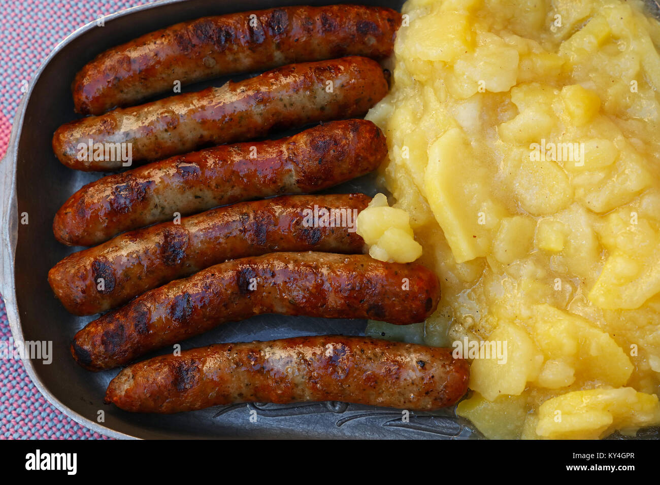 Close up portion of grilled Nuremberg Bratwurst sausages with side dish
