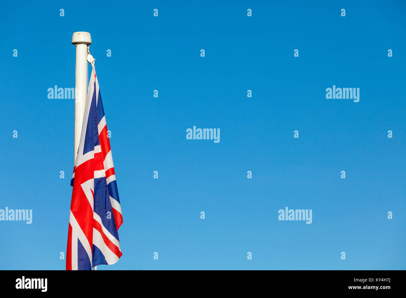Union Jack flag on a bright blue sky background Stock Photo - Alamy