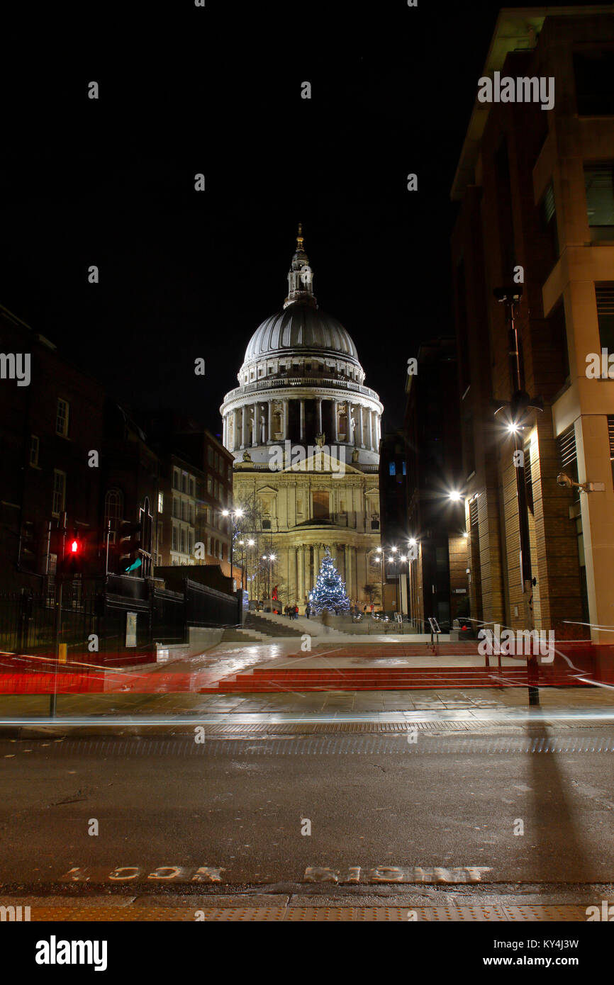 Saint Paul's Cathedral at night looking North from Queen Victoria street, with light trails from passing buses. Stock Photo