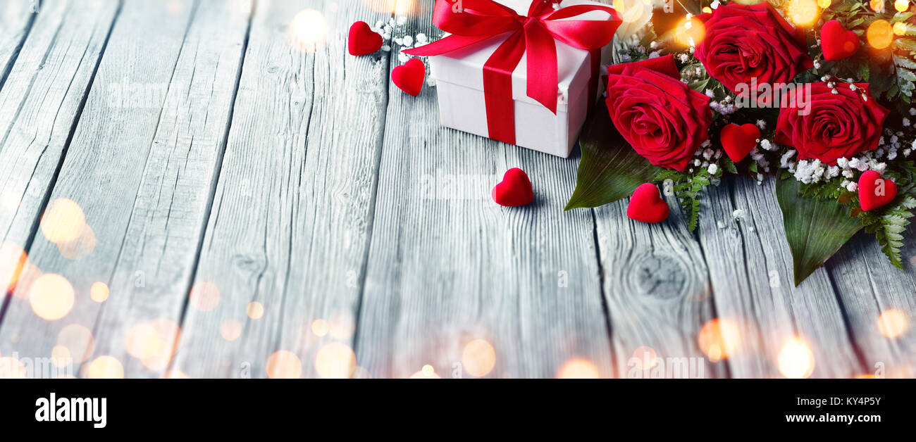 Valentines Card - Gift Box And Roses On Wooden Table With Lights Stock ...