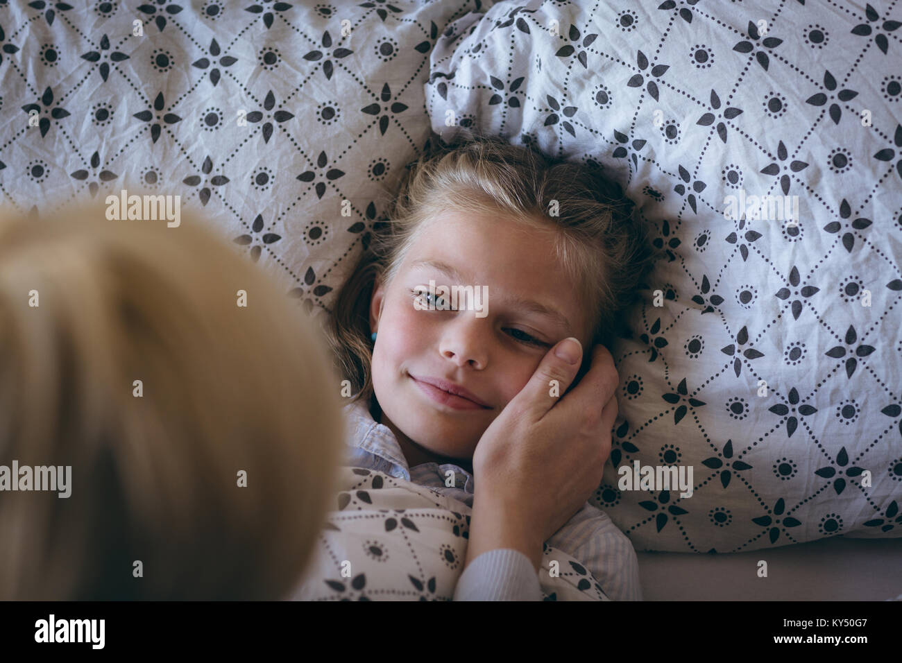 Mom wakes up her daughter in the morning Stock Photo