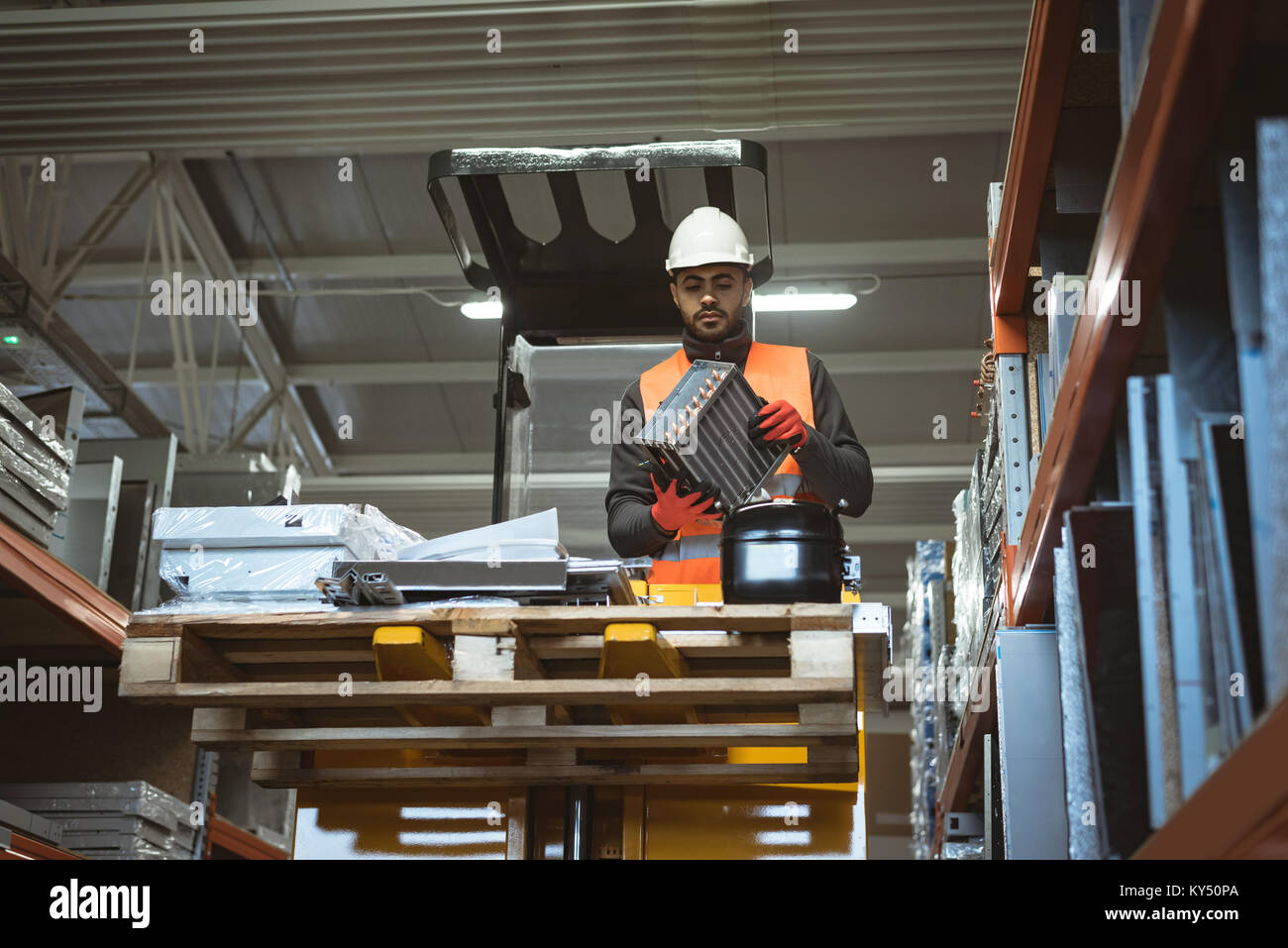 Male worker checking machine part Stock Photo - Alamy