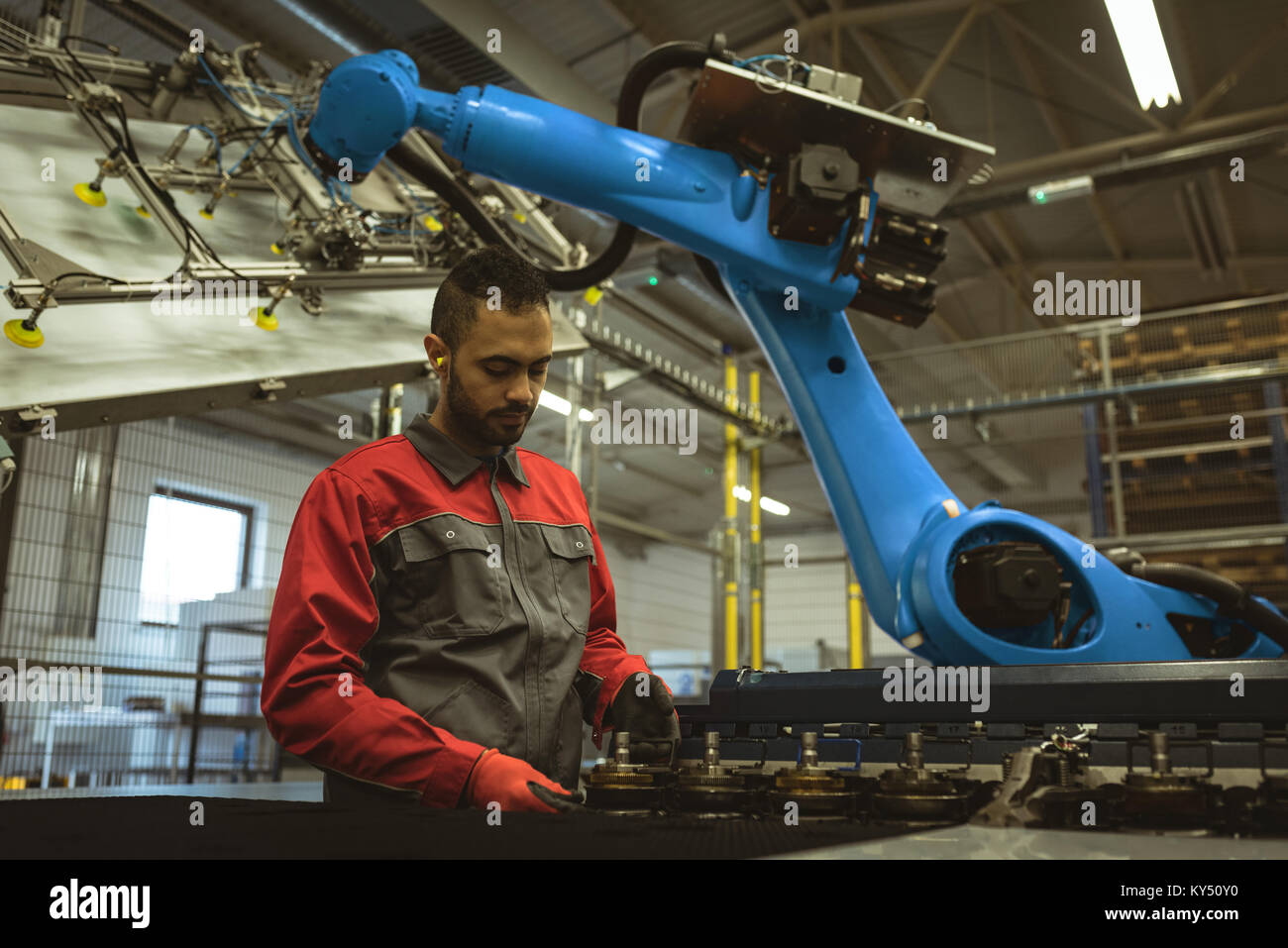 Photo Worker Checking Machine Male worker checking a machine part Stock Photo - Alamy