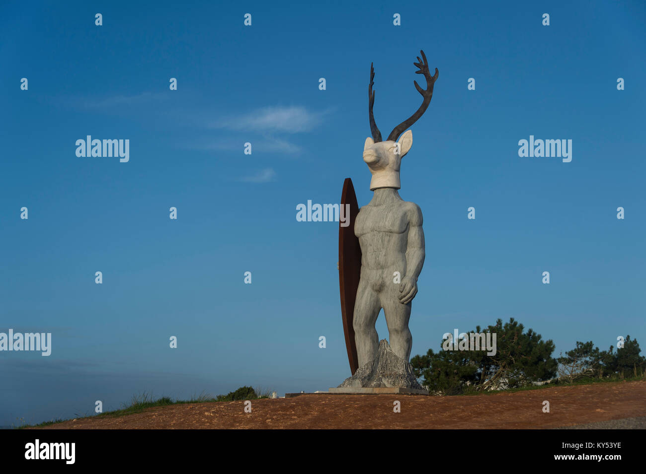 'Veado' surfer with a deers head statue at Praia do Norte in Nazaré, by sculptor Adália Alberto, Nazaré, Portugal Stock Photo