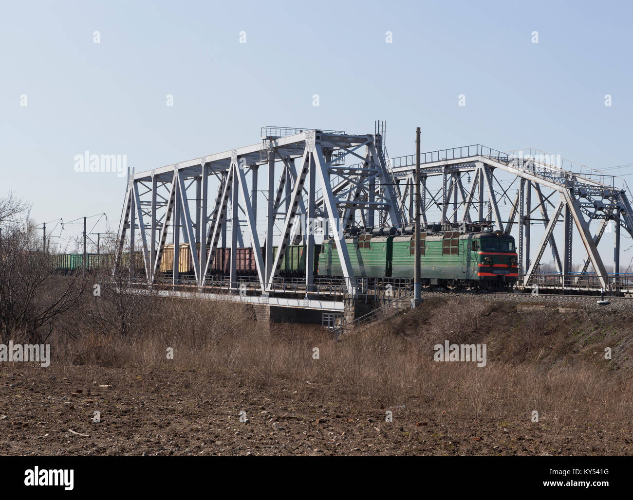 Cargo train rides on the railway bridge Stock Photo - Alamy