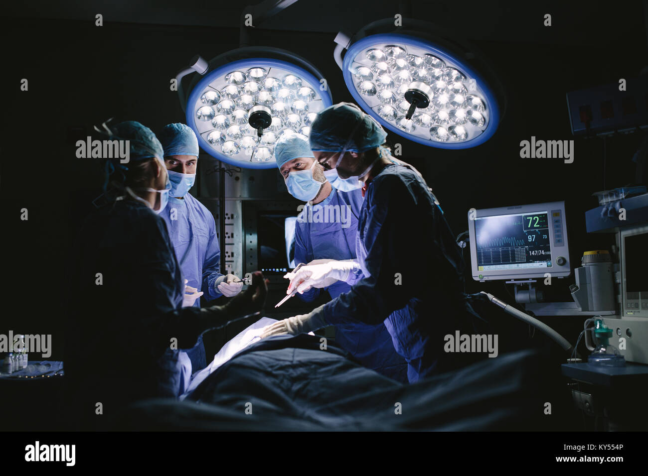 Medical team performing surgery in hospital. Group of surgeons at work