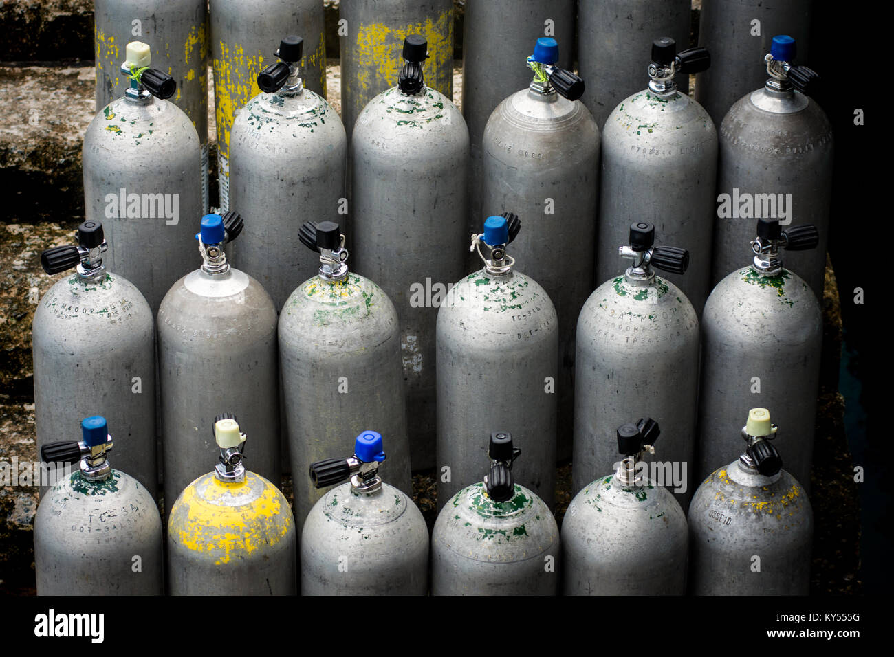 Collection of grey scuba diving air oxygen tanks waiting lined up. Stock Photo