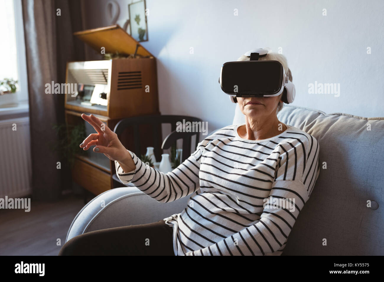 Senior woman wearing a virtual reality headset Stock Photo - Alamy