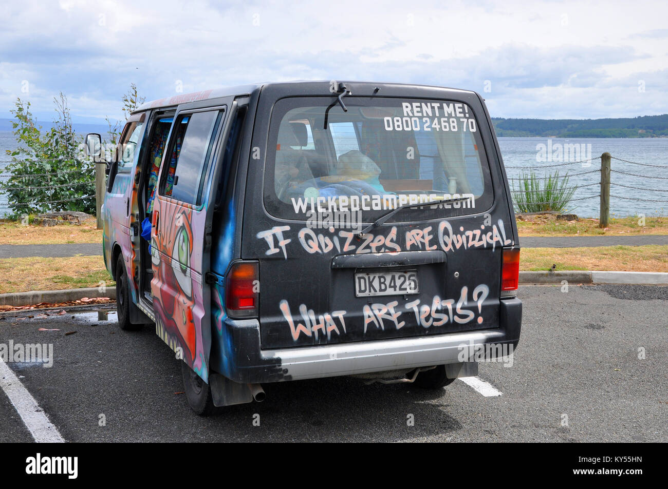 Wicked Campervan hire in New Zealand operate graffiti covered camper vans and motorhomes. Comic slogan. Lake Taupo Photo - Alamy