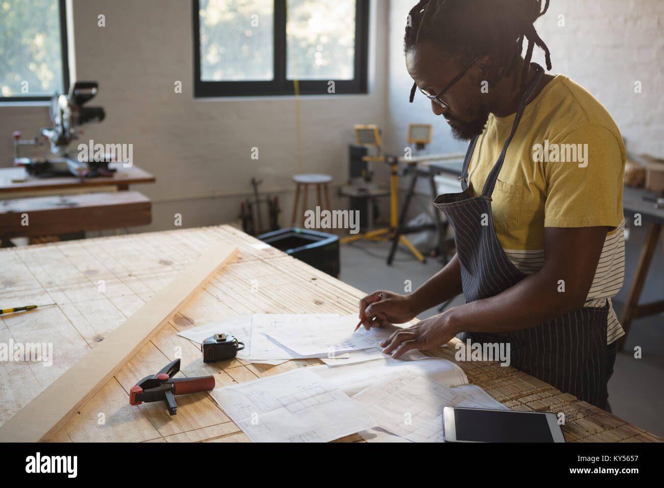 Carpenter working at table Stock Photo Alamy