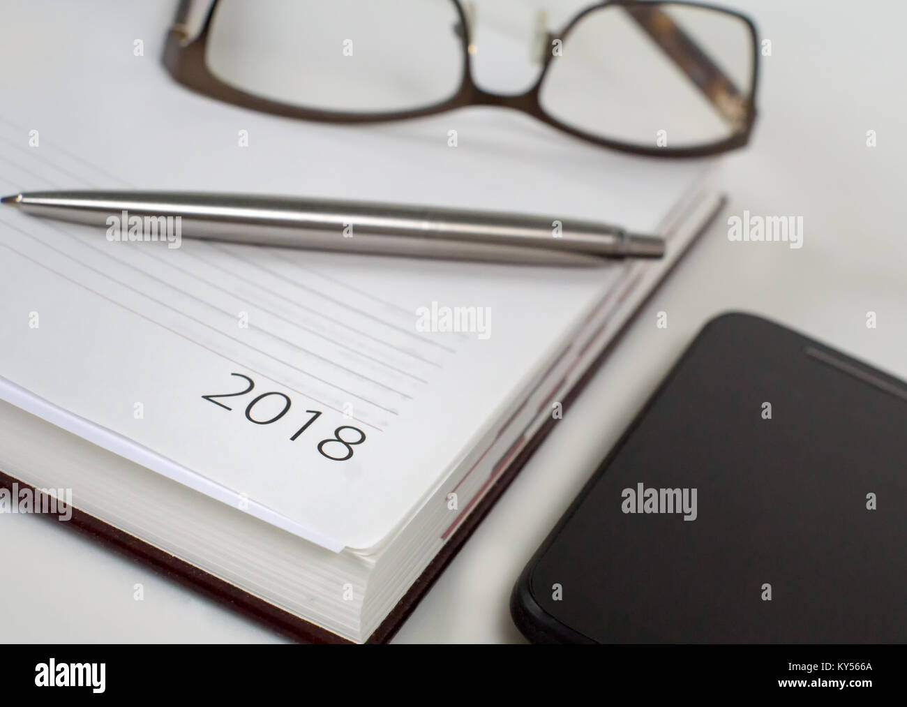 New Year 2018 office organizer calendar and sliver ballpen. Selective focus Stock Photo