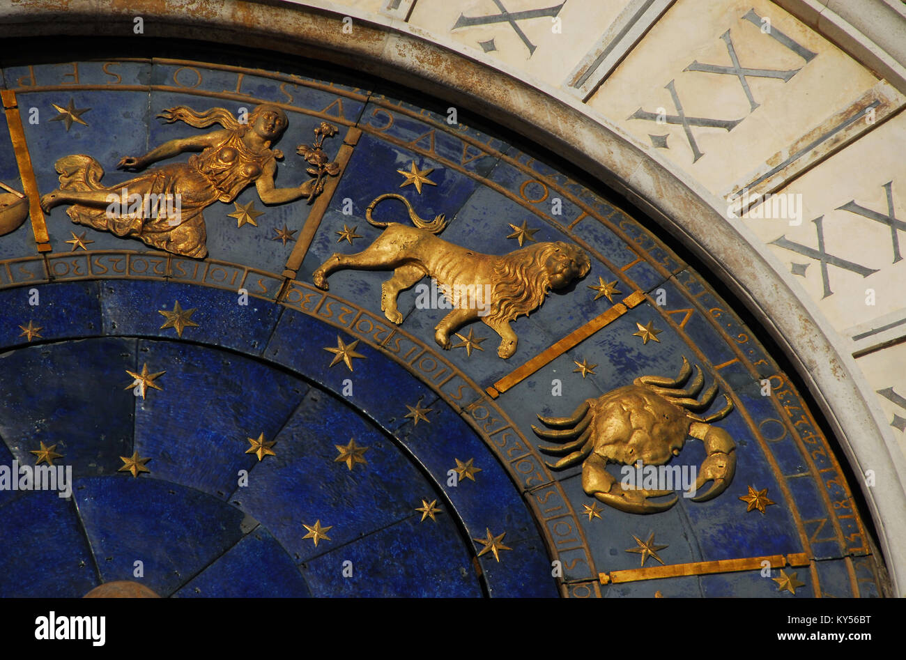 Ancient time and Astrology. Detail of Saint Mark Square renaissance Clock Tower in Venice with zodiac signs Leo, Cancer, Virgo, planet and stars (15th Stock Photo