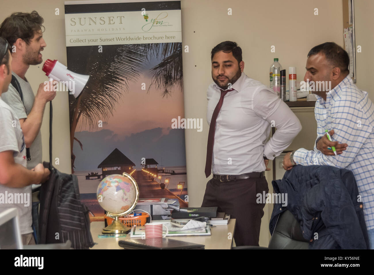 Usman Bhatti (in red tie) is confronted by UVW General Secretary about the £5,500 he still owes from the £6,500 of Carlos's life savings handed over as deposit and advance rent for a property that Bhatti was unable to provide. Stock Photo