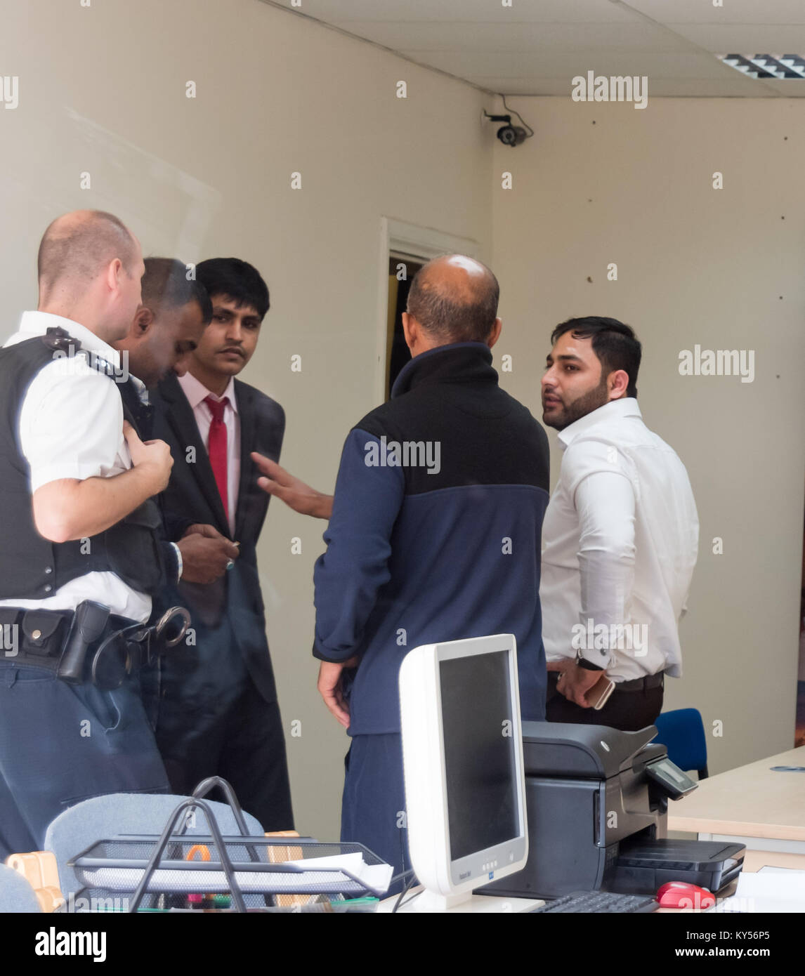 Eventually the police arrive and talk with Usman Bhatti, a neighbour and another business owner about the protest. Stock Photo