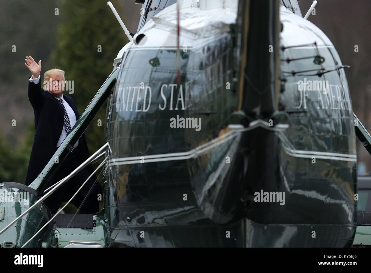 Bethesda, United States Of America. 12th Jan, 2018. United States President Donald J. Trump waves to journalists as he boards Marine One on departure from Walter Reed National Military Medical Center following his annual physical examination January 12, 2018 in Bethesda, Maryland. Trump will next travel to Florida to spend the Dr. Martin Luther King Jr. Day holiday weekend at his Mar-a-Lago resort. Credit: Chip Somodevilla/Pool via CNP Photo via Credit: Newscom/Alamy Live News Stock Photo