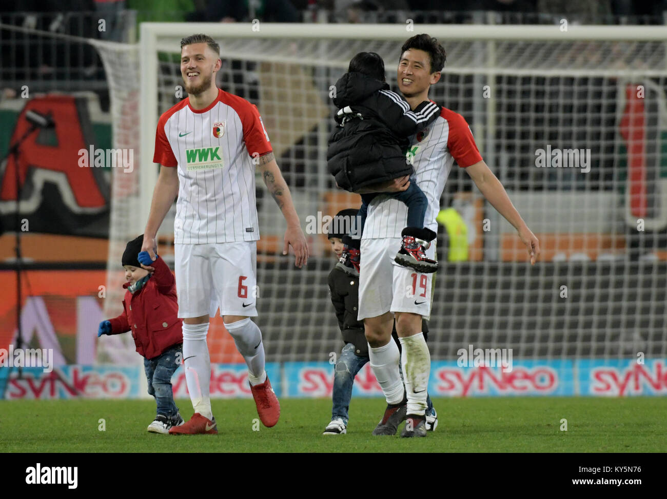 Augsburg S Jeffrey Gouweleeuw L And Ja Cheol Koo Leave The Pitch With Their Children After The German Bundesliga Football Match Between Fc Augsburg And Hamburger Sv At The Wwk Arena In Augsburg Germany 13