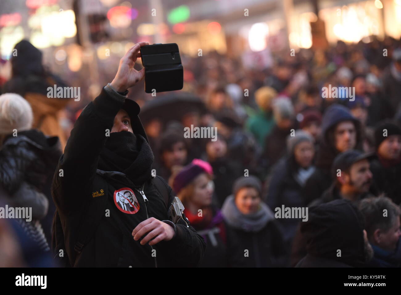 Vienna, Austria. 13th Jan, 2018. hooded protester takes a selfie during an anti-government demonstration. Credit: Vincent Sufiyan/Alamy Live News Stock Photo