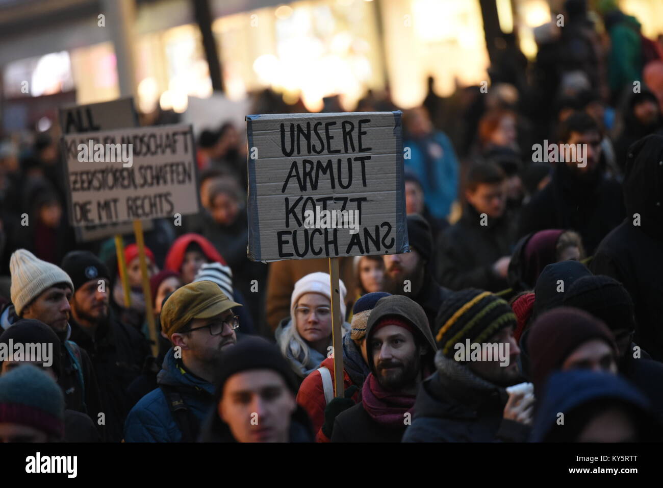 Vienna, Austria. 13th Jan, 2018. protester during an anti-government demonstration. the sign reads 'my poverty makes you sick'. Credit: Vincent Sufiyan/Alamy Live News Stock Photo