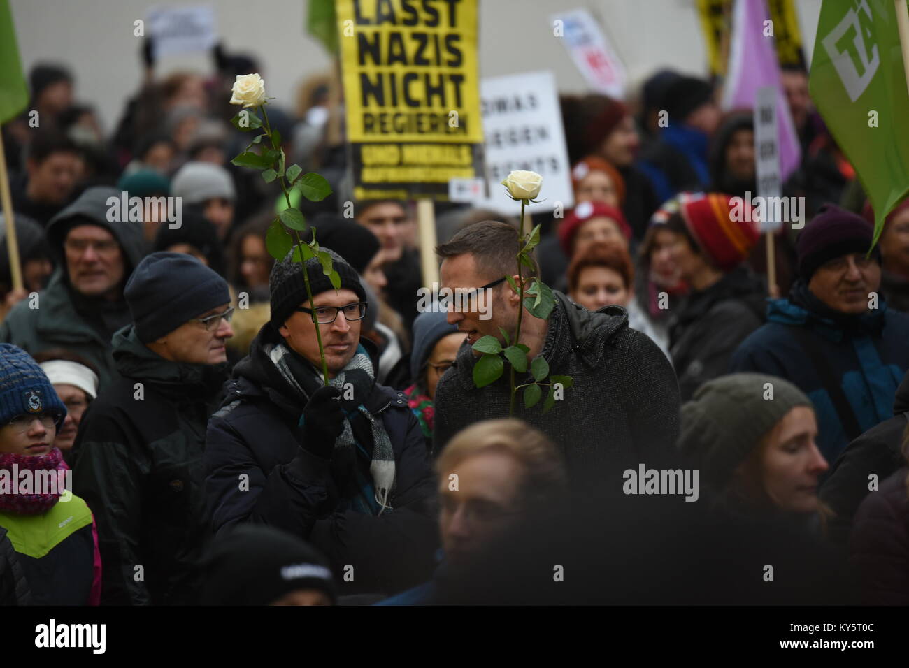 Vienna, Austria. 13th Jan, 2018. protesters holding roses during as anti-government demonstration. Credit: Vincent Sufiyan/Alamy Live News Stock Photo