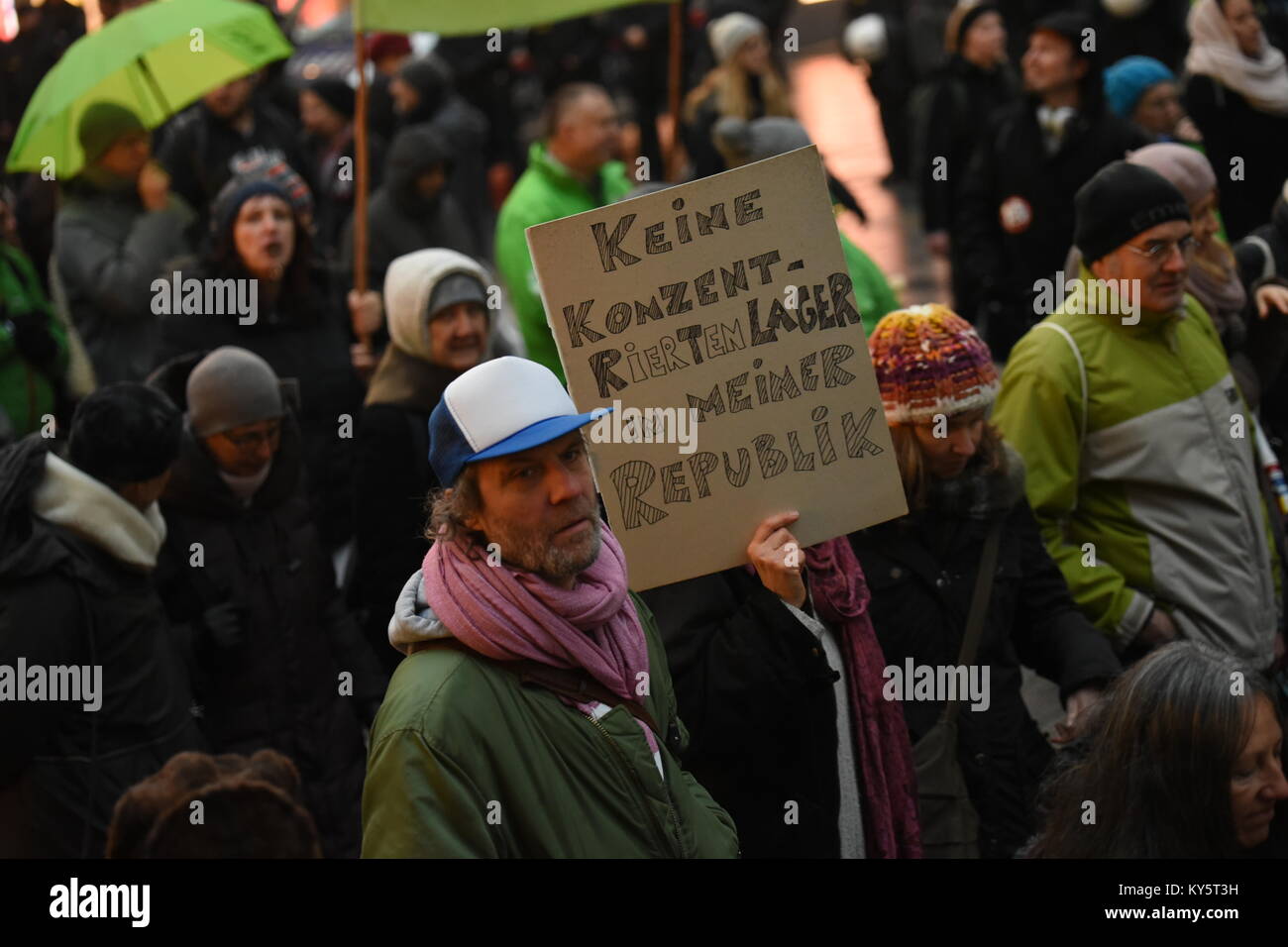 Vienna, Austria. 13th Jan, 2018. protester holding a sign during an anti-government demonstration. the sign reads 'no concentration camps in my republic'.  Credit: Vincent Sufiyan/Alamy Live News Stock Photo