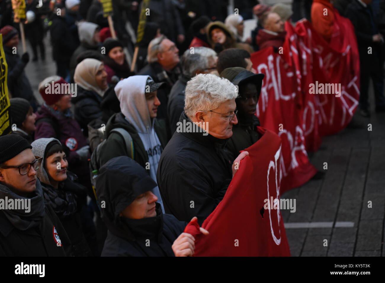 Vienna, Austria. 13th Jan, 2018. protesters carrying a banner through Vienna's main shopping street during an anti-government demonstration. Credit: Vincent Sufiyan/Alamy Live News Stock Photo
