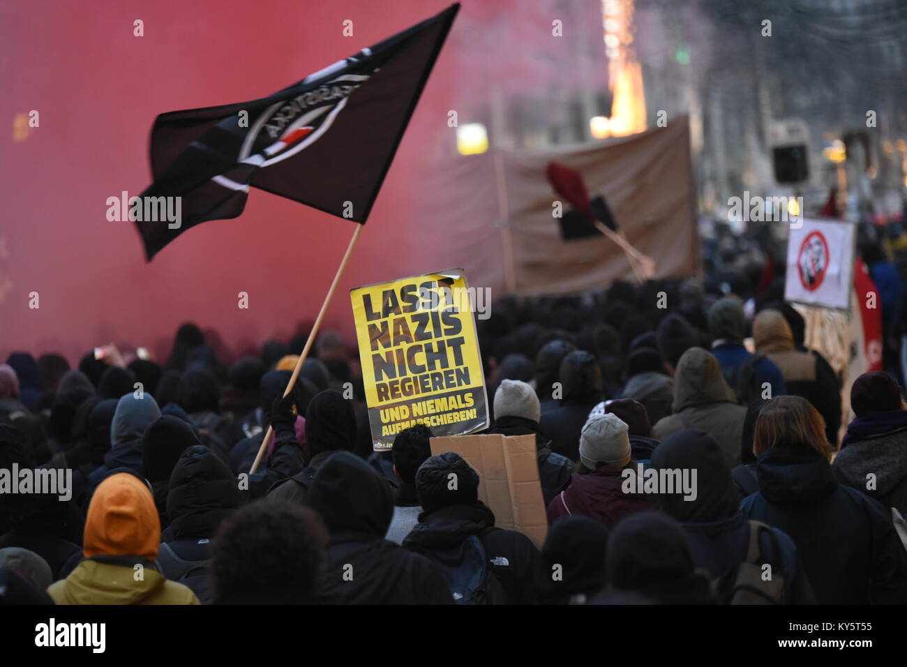 Vienna, Austria. 13th Jan, 2018. protesters waving flags and  carrying a sign during an anti-government demonstration. the sign reads 'don't let Nazis into government'. Credit: Vincent Sufiyan/Alamy Live News Stock Photo