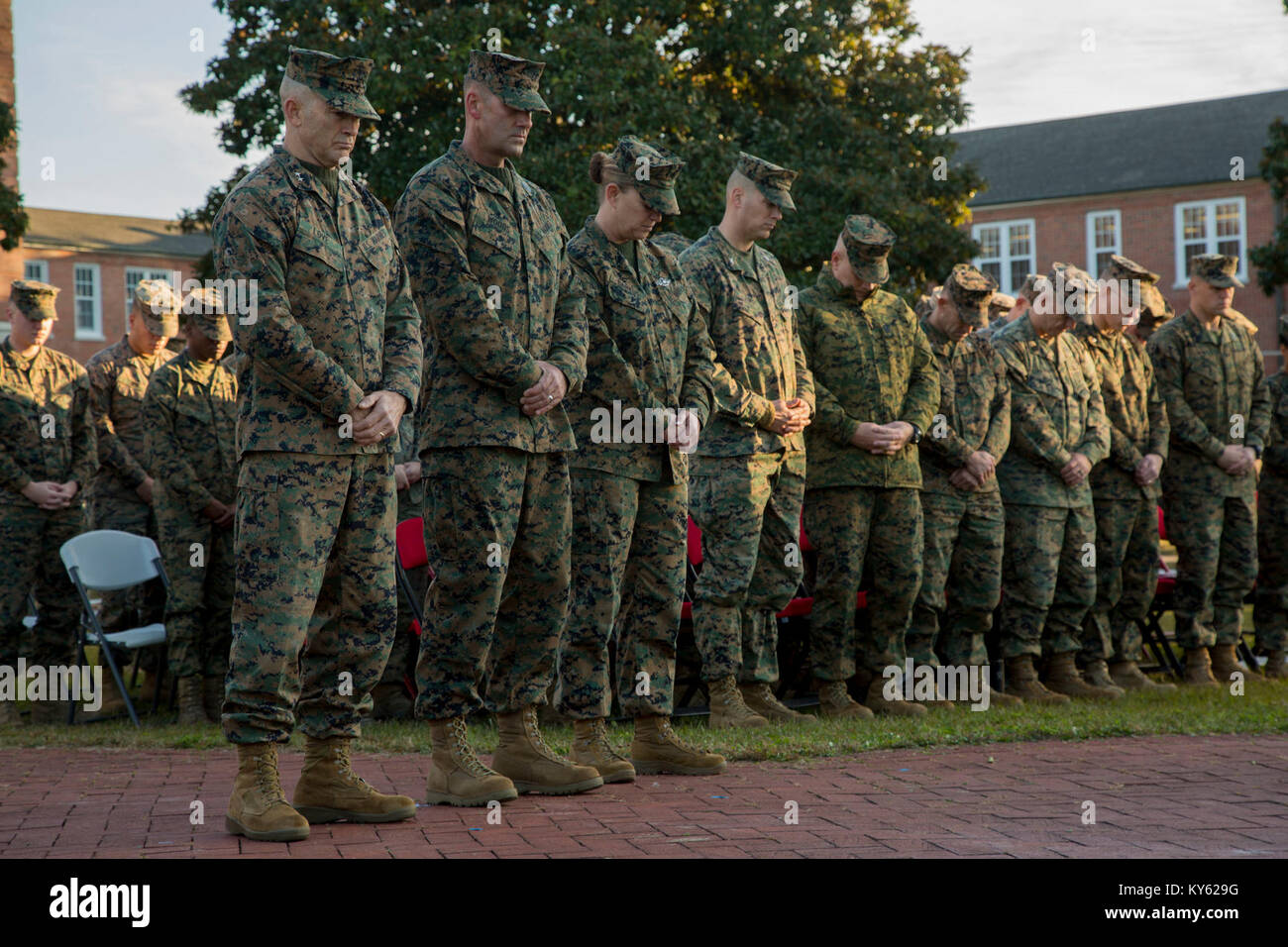 U.S. Marine Corps Maj. Gen. John K. Love, commanding general, 2nd Marine Division (2d MARDIV), left, Sgt. Maj. Michael P. Woods, sergeant major, 2d MARDIV, Senior Chief Petty Officer Jill Bankus bow their heads for the invocation during a morning colors award ceremony on Camp Lejeune, N.C., Dec. 12, 2017. The ceremony is held to honor colors as well as award Marines and Sailors. (U.S. Marine Corps Stock Photo