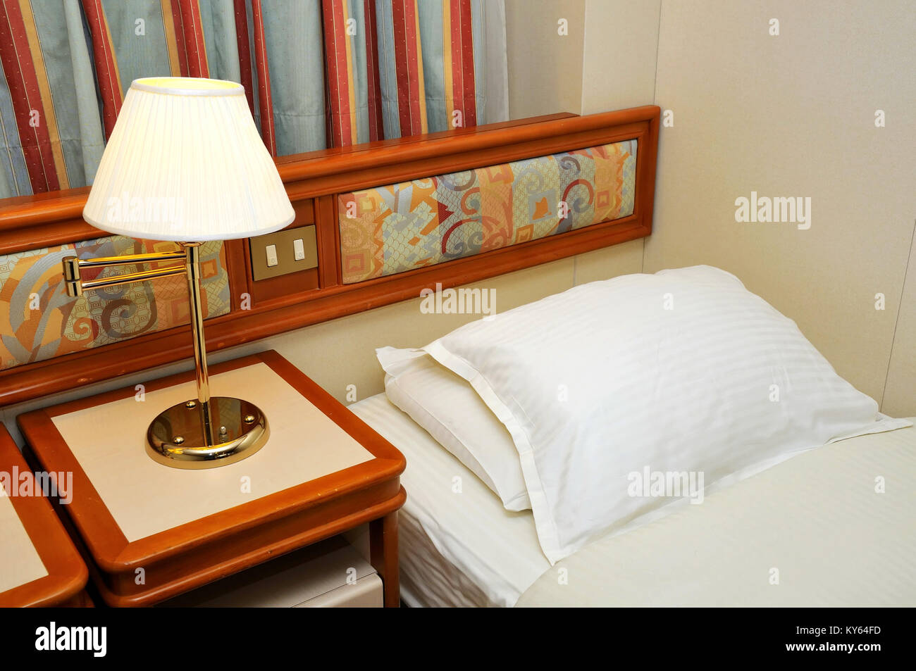 High Class Bedroom On Cruise Ship With Lighted Table Lamp