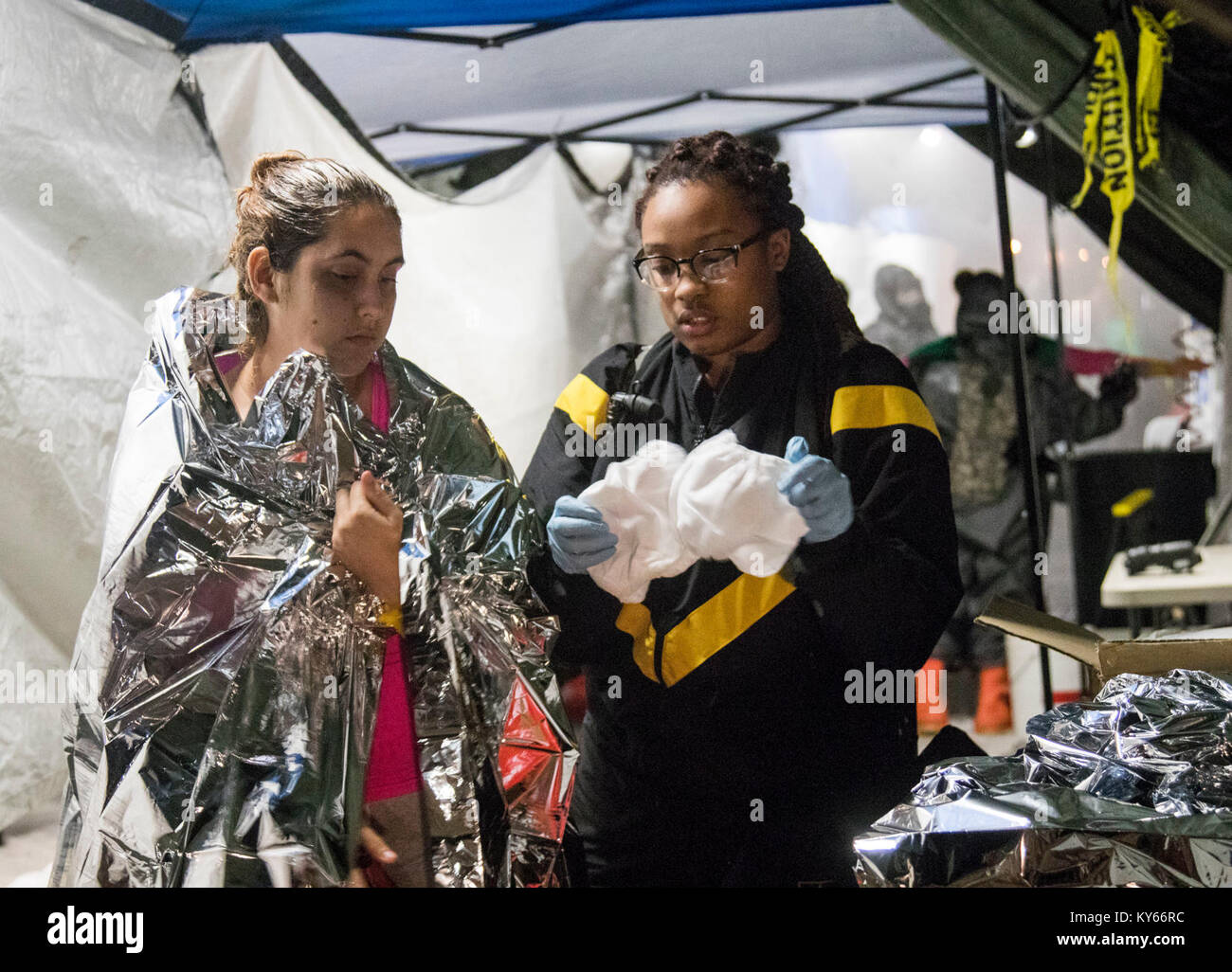 U.S. Army Soldier provides a space blanket to simulated casualties during a Mass Casualty Decontamination exercise at the Homestead-Miami Speedway, in Miami-Dade, Florida, Jan. 9, 2018. This is the 3rd in a series of joint training exercises between Active Duty, Guard, and Reserve Army units and local municipalities across the United States. This JTE focused on the decontamination and transportation of casualties in a simulated mass chemical attack. (DoD Stock Photo