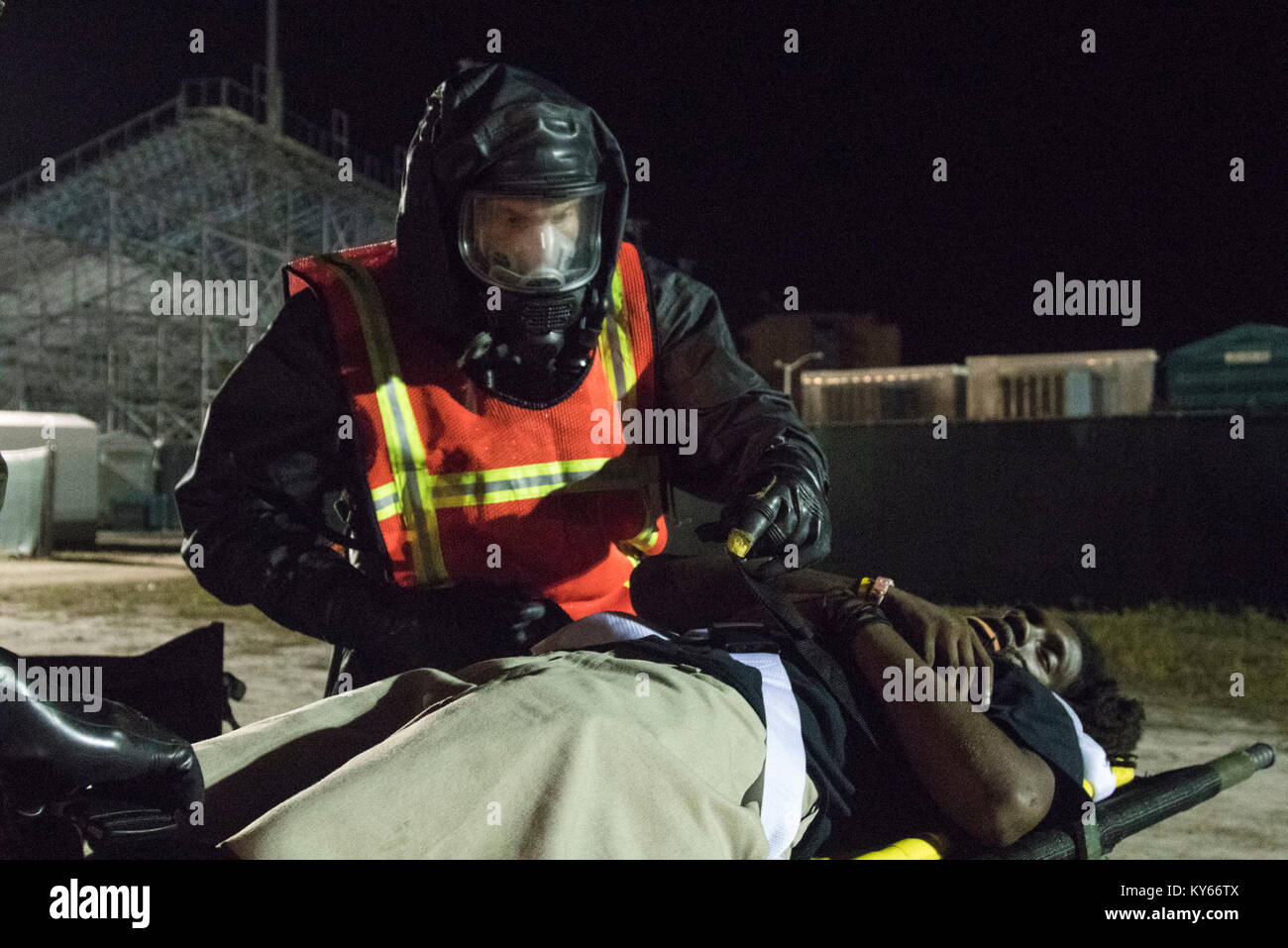 U.S. Army Soldier exanimate simulated casualties during a Mass Casualty Decontamination exercise at the Homestead-Miami Speedway, in Miami-Dade, Florida, Jan. 9, 2018. This is the 3rd in a series of joint training exercises between Active Duty, Guard, and Reserve Army units and local municipalities across the United States. This JTE focused on the decontamination and transportation of casualties in a simulated mass chemical attack. (DoD Stock Photo